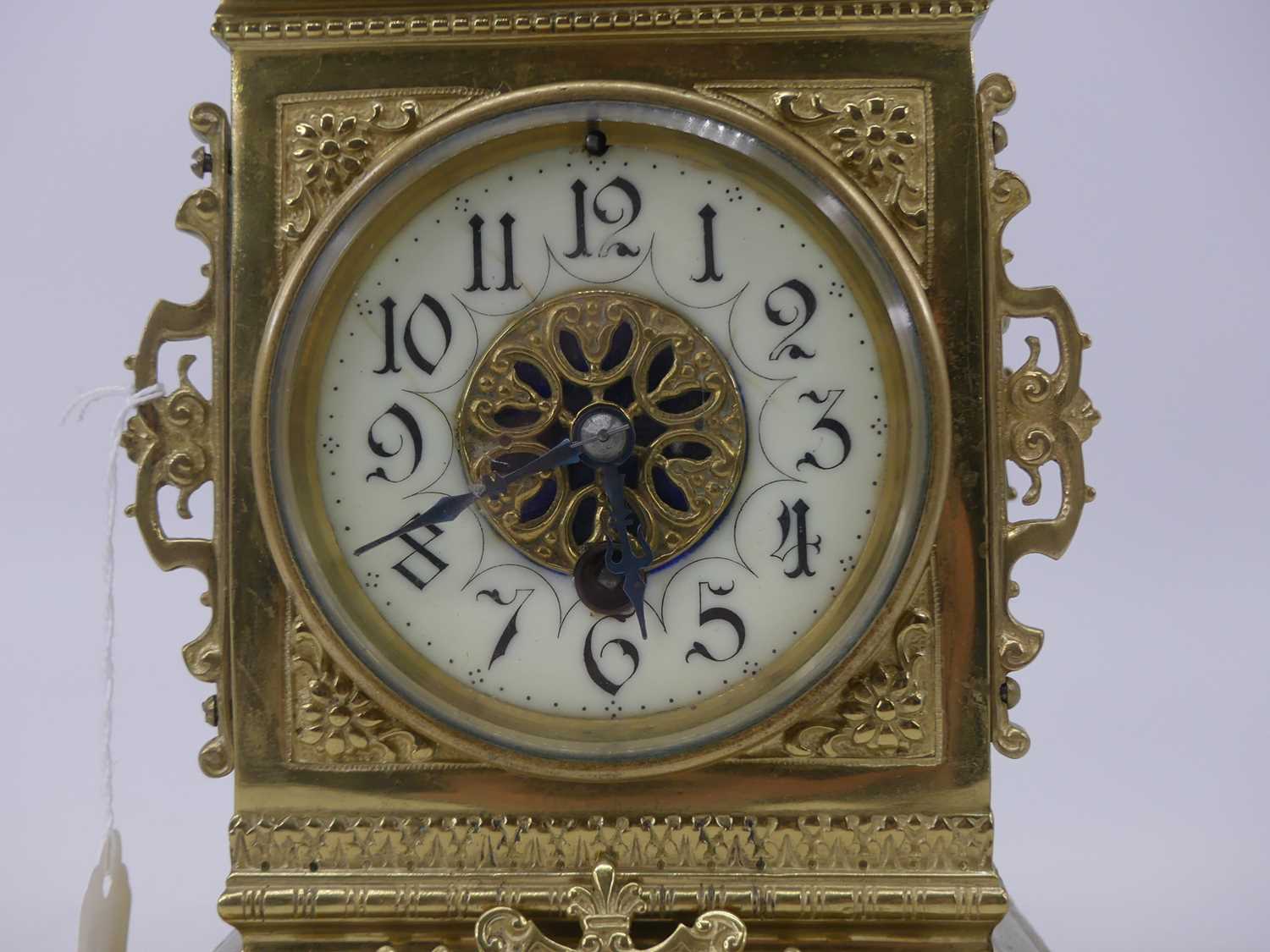 A late 19th century brass cased mantel clock, having a caddy-type top above an enamelled chapter - Image 2 of 4