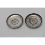 A pair of reproduction Chinese dishes, each inset with a coinBelieved to be a copy of a period