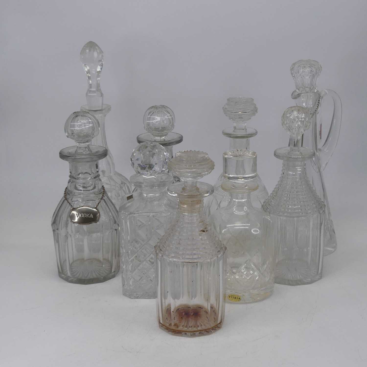 A pair of 19th century cut glass decanters, each having facet cut body with ring neck and fluted