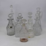 A pair of 19th century cut glass decanters, each having facet cut body with ring neck and fluted