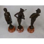 A set of three reproduction bronze figures of ladies, each mounted upon a socle marble plinth, the