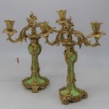 A pair of table candelabra in the Rococo style, each having a green glazed porcelain body with