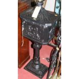 A freestanding contemporary black painted cast iron pedestal floor mounted letter-box, h.110cm