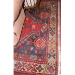 A Persian woollen red ground Shiraz rug, with all over floral geometric ground, 278 x 197cm