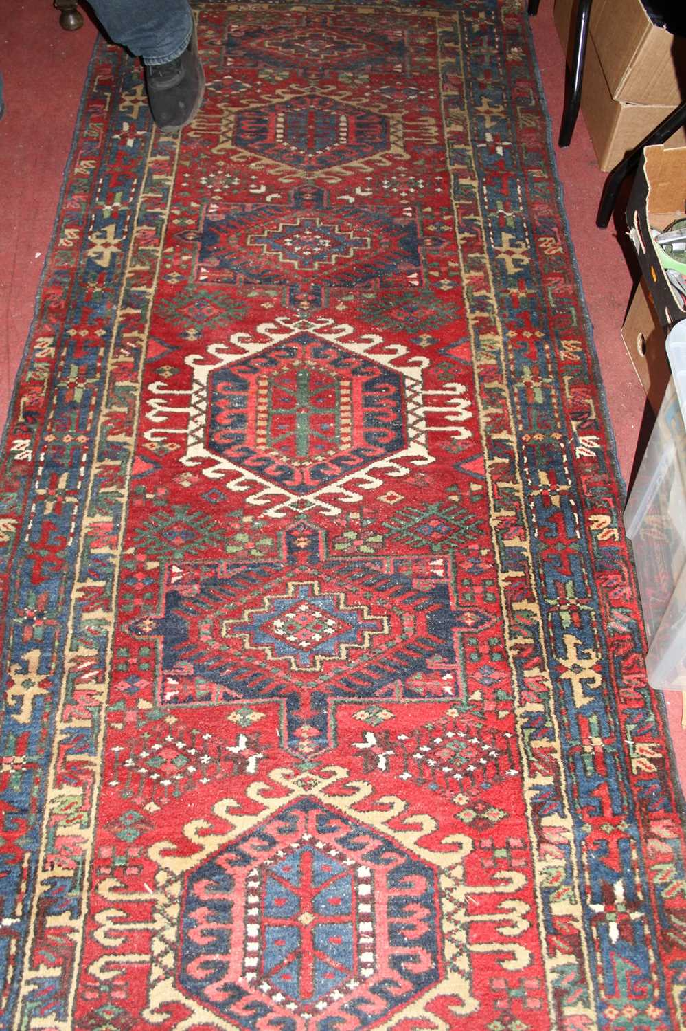 A Persian woollen red ground Shiraz hall runner, the geometric lozenge central ground within - Image 3 of 3