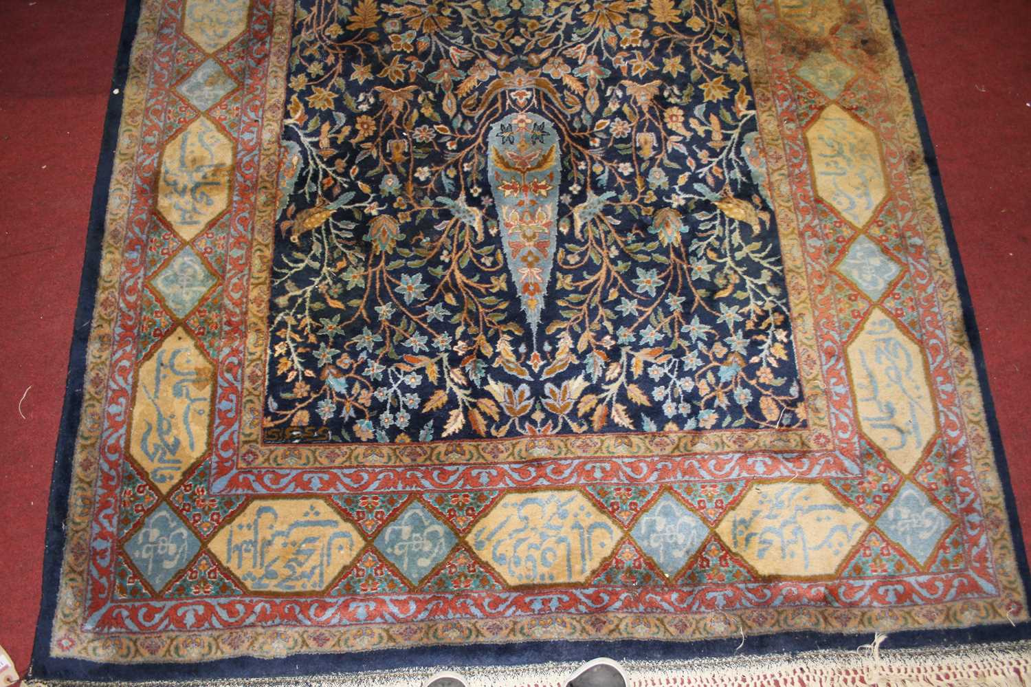 A Persian woollen blue ground rug, the heavily decorated central ground within trailing tramline - Image 2 of 4