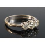 An 18ct white gold diamond three stone ring, featuring three graduated round brilliant cut