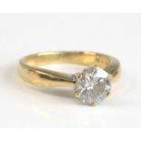 An 18ct yellow and white gold, diamond solitaire ring, comprising a round brilliant cut diamond in a