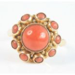 A yellow metal coral Etruscan style circular cluster ring, having a centre 8mm round coral