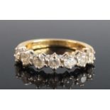 An 18ct yellow and white gold, diamond seven-stone half-hoop eternity ring, comprising seven round