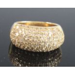 A yellow metal bombe cluster ring, pavé set with 120 round white stones (possibly colourless