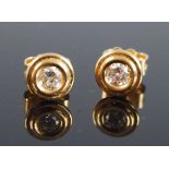 A pair of 18ct yellow gold diamond stud earrings each featuring a round brilliant cut diamond in a