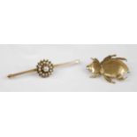 Two yellow metal brooches to include a bar brooch with a centre circular cluster set with 13 1.9