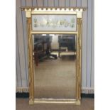 A Regency style giltwood wall mirror, having an inverted breakfront ball decorated top over verre