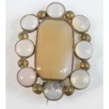 A yellow metal chalcedony oval panel brooch, featuring a 30 x 18 x 4.15mm octagonal chalcedony