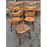 A set of nine 19th century elm and fruitwood barback kitchen chairs, raised on turned supports, w.