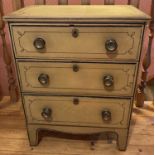 A Regency painted pine chest of three long graduated drawers, having embossed turned brass
