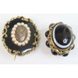 Two brooches, being a yellow metal oval Victorian memorial brooch, comprising a centre oval