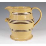 A large mochaware jug, 19th century, decorated with brown bands, h.25cmNo chips or cracks, but it is