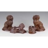 A pair of brown glazed stoneware models of spaniels, probably Brampton, late 19th century, each