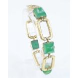 A yellow metal chrysoprase bracelet, comprising four domed square chrysoprase cabochons