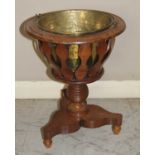 A 19th century mahogany circular jardiniere stand, with inset brass liner and swing carry handle, to