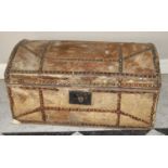 A 19th century hide, leather and brass studded domed hinge topped travelling chest, with paper lined