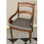 A Regency mahogany barback scroll elbow chair, having a floral upholstered stuffover seat, on bobbin