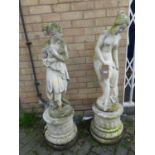 A pair of reconstituted stone garden statues, each in the form of standing semi-nude classical