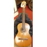 A guitar with label for A. Dotras, Cordoba, to inside, length 96cm, with leather carrying bag (2)See