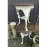 A pair of cast iron based and later white painted circular pub tables, each with stained pine top