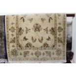 A Persian style machine-woven cream ground rug, 150 x 92cm