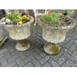 A pair of reconstituted stone circular squat pedestal garden planters, each in the classical taste