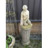 A reconstituted stone garden figure of a seated classical nude woman, height 49cm, raised on