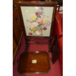 A Victorian mahogany and floral tapestry inset fire screen, with rise and fall panel, together