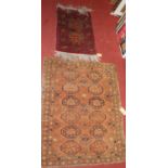 A small Persian rust ground woollen Bokhara hall rug, 95 x 78cm; together with one other smaller