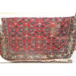 A Persian woollen red ground Bokhara rug, 160 x 105cmVery dirty. Fringe is missing partially at