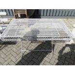 A grey painted metal strapwork X-frame garden potting up table, of rectangular form, length 130cm