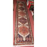 A Persian woollen cream ground Shiraz long hall runner, 295 x 70cm
