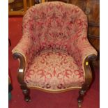 A mid-Victorian rosewood and red floral buttoned upholstered tub scroll armchair, raised on turned