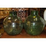 A Viresa green glass carboy, of bulbous form, h.36cm; together with a further very similar carboy,
