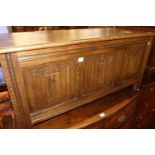 A contemporary moulded oak linen fold three-panelled hinge top blanket chest, width 105cm