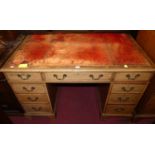 A reproduction faded mahogany and gilt tooled red leather inset twin pedestal writing desk, width