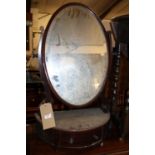 An Edwardian mahogany and chequer strung oval bevelled dressing mirror, raised on demi-lune single