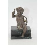 A circa 1900 French bronze figure, modelled as Cupid in seated pose with bow & arrow in hand, on