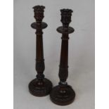 A pair of 20th century carved mahogany table candlesticks, each with fluted and acanthus decoration,