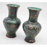 A pair of early 20th century Japanese cloisonne vases, of baluster form, on a green ground with