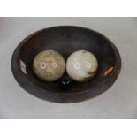Two polished hardstone balls, each dia.7cm; together with a carved beech bowl, dia.24cm