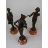 A set of three reproduction bronze figures of ladies, each mounted upon a socle marble plinth, the