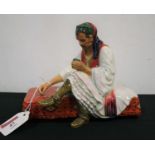 A pottery model of a gentleman, in seated pose, probably a prototype for the Albanian Dice Player by